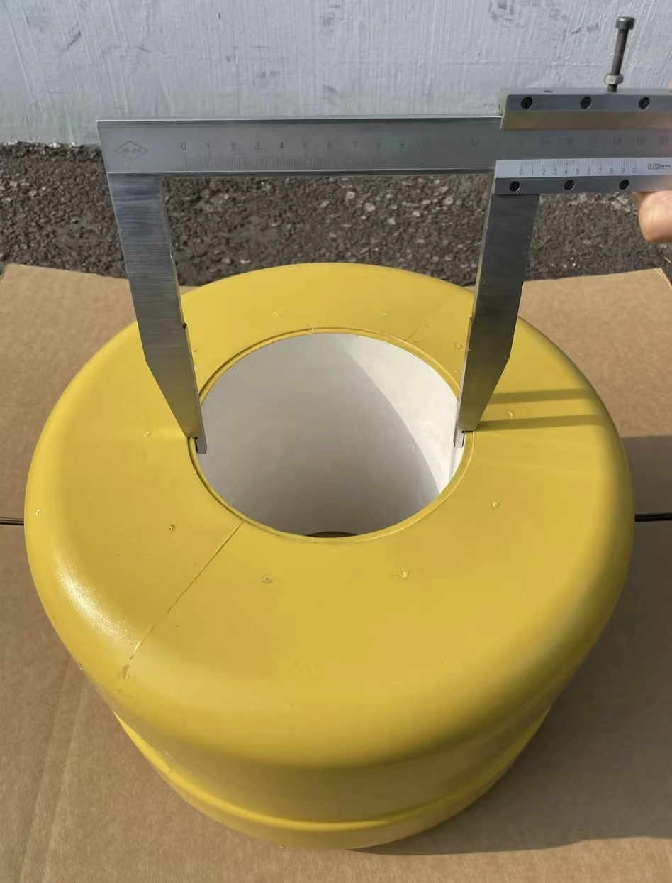 Caliper measuring the central bore of a yellow roller barrier component