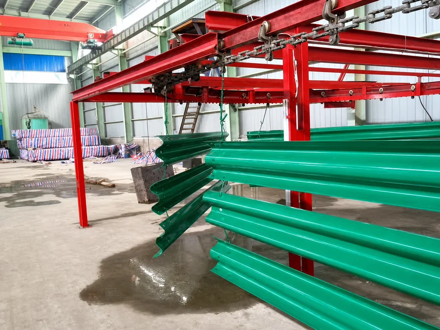 Green coated guardrail sections on a production line